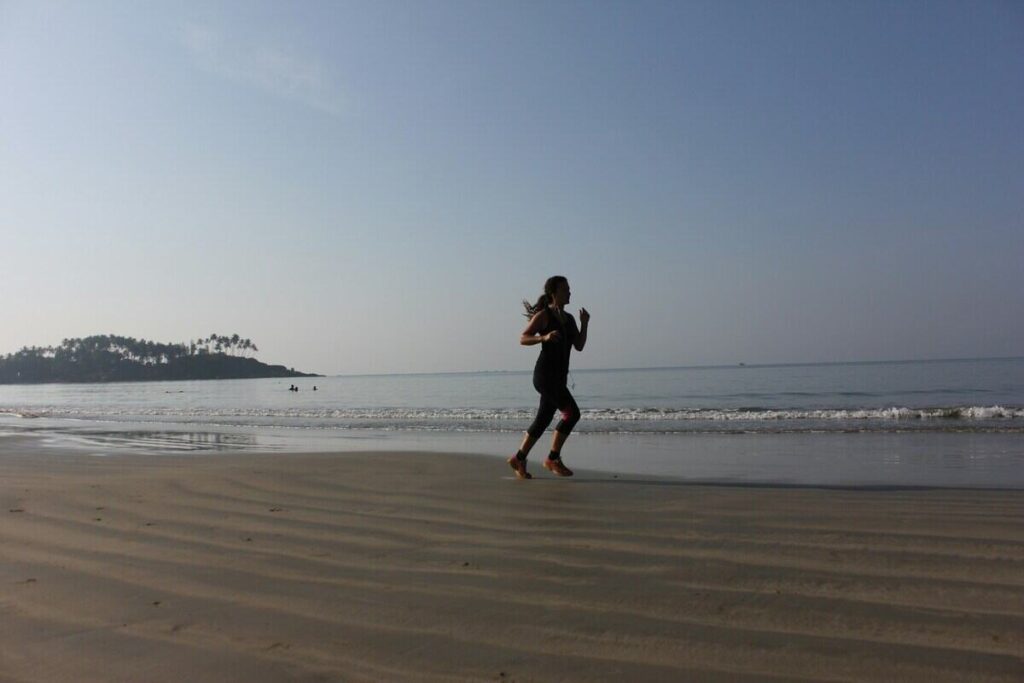 una donna corre su una spiaggia