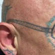 Si sveglia con i Rayban tatuati sul volto