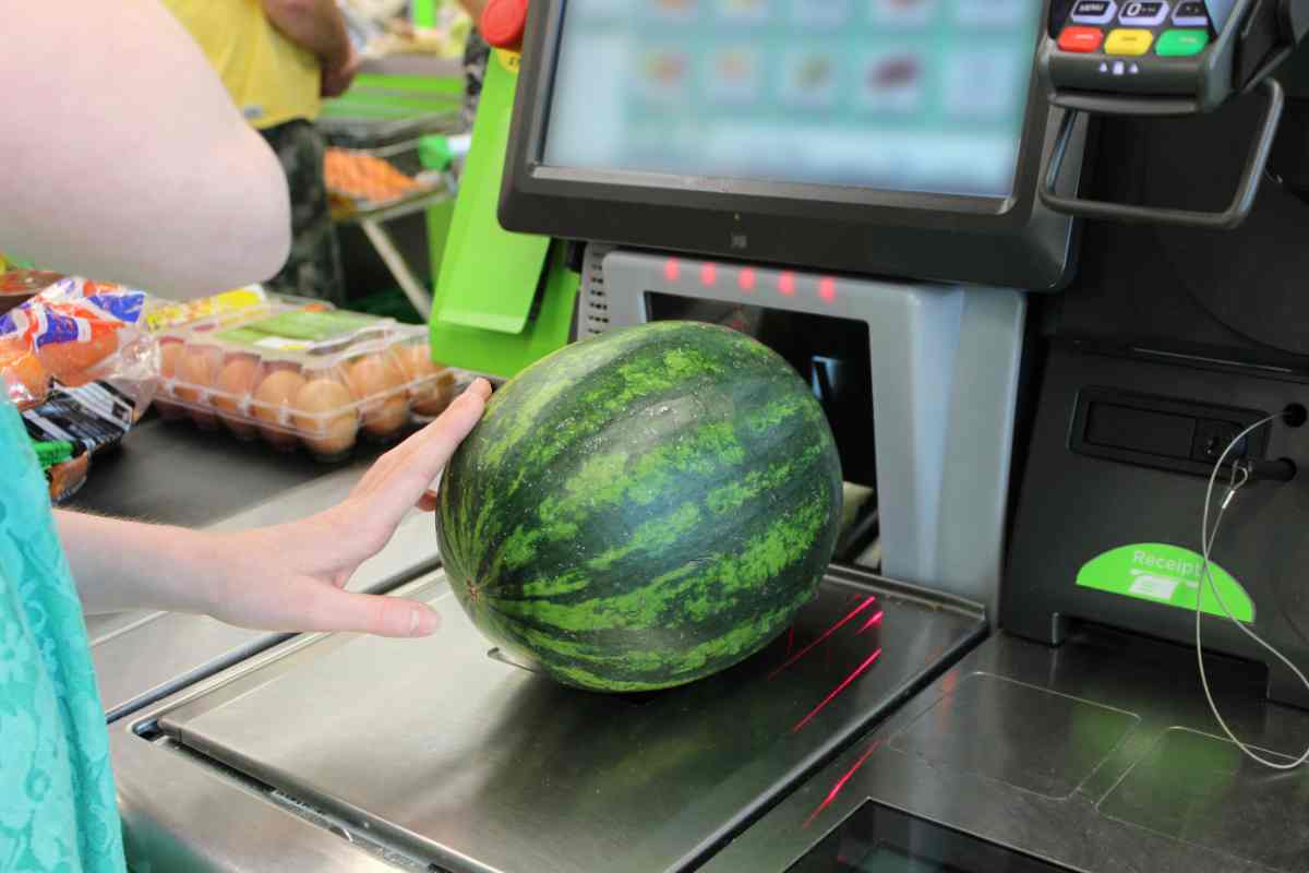 donna pesa anguria su cassa automatica in supermercato