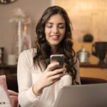 Ragazza al telefono e davanti al laptop