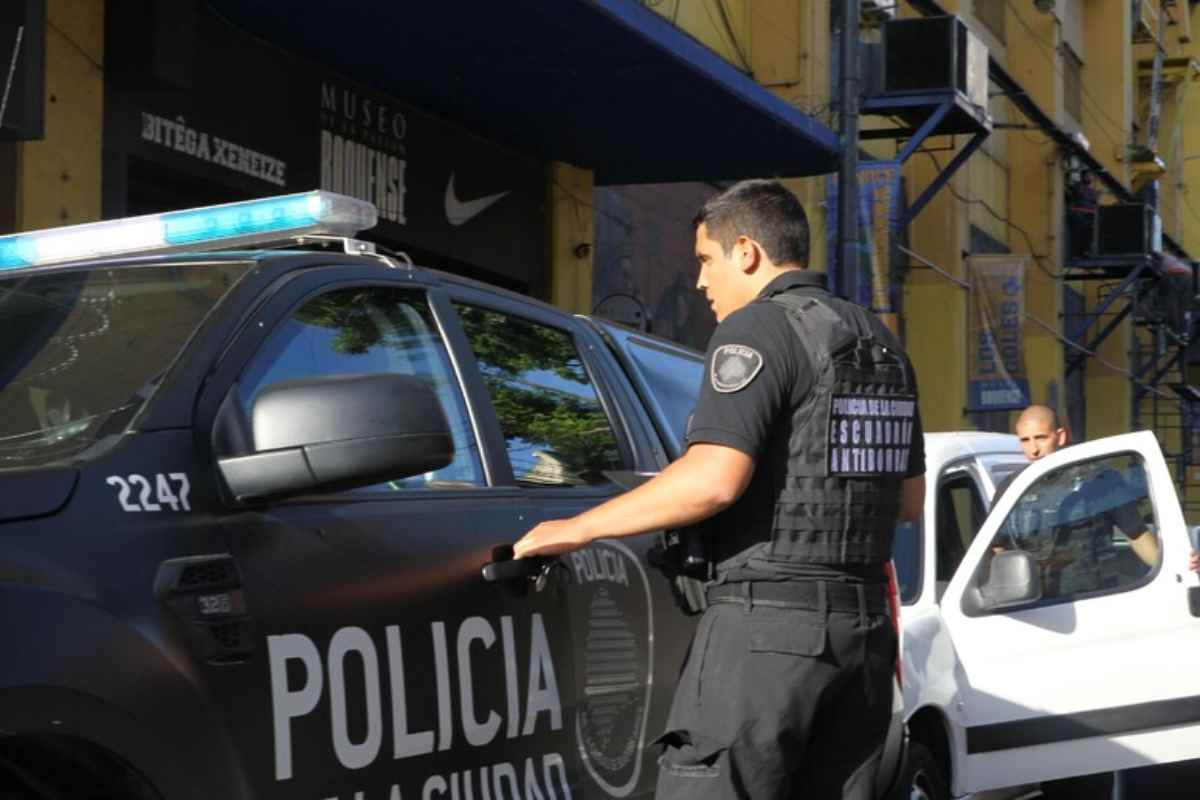 Un poliziotto in Argentina accanto alla sua auto