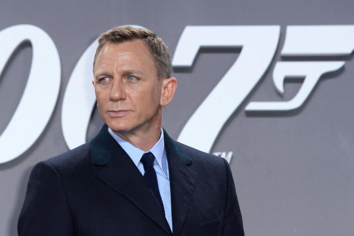 L'attore Daniel Craig con il poster di 007 alle sue spalle