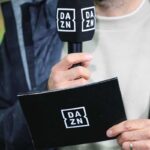 Giornalista con cartellina e microfono DAZN