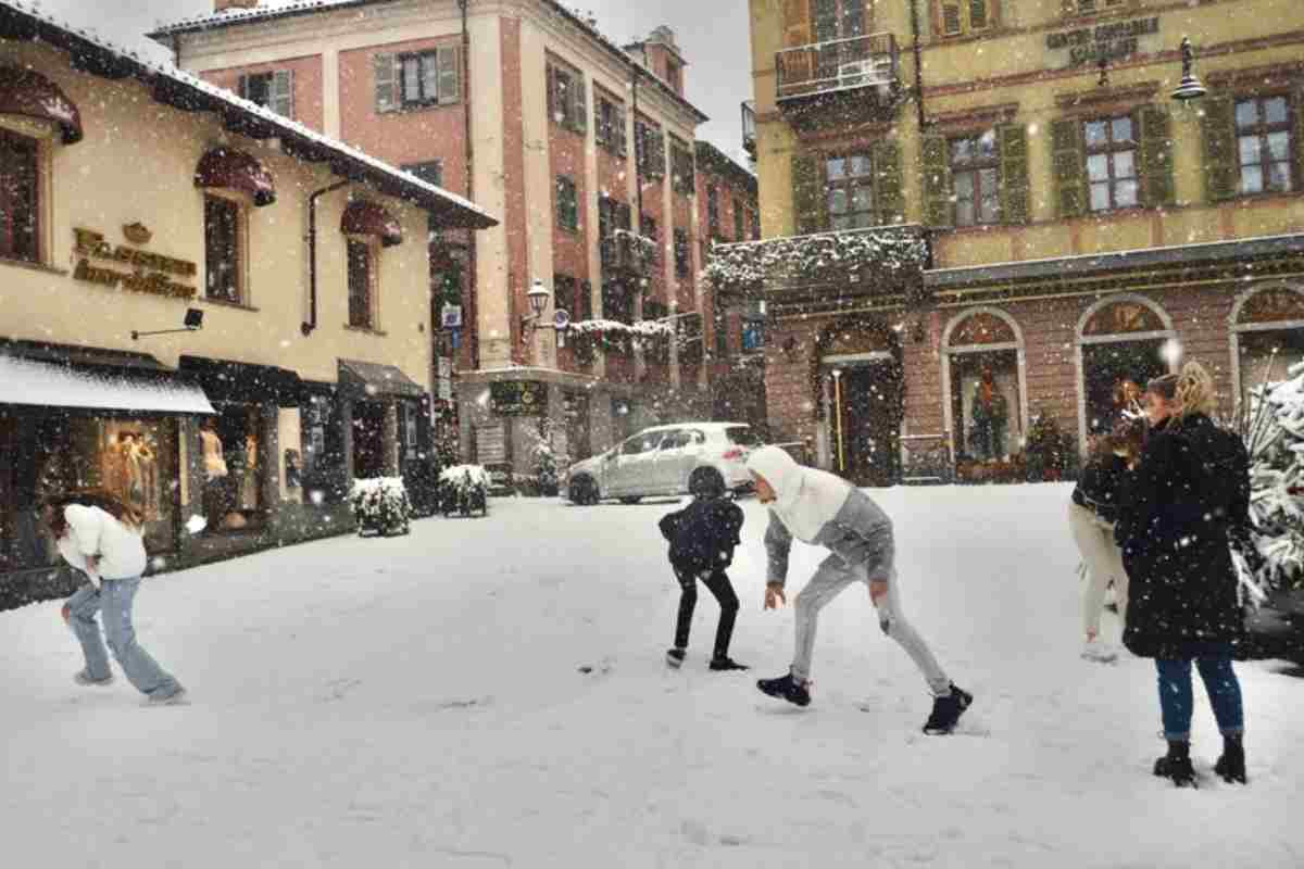 Due bambini giocano con la neve in inverno