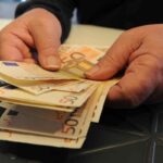 Un dipendente di una banca conta i soldi