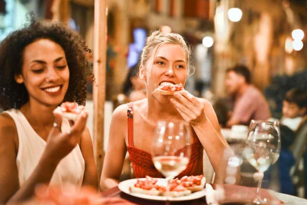 due giovani donne mangiano italiano