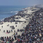 Internally displaced Palestinians make their way from southern to northern Gaza along Al Rashid road, central Gaza Strip, 27 January 2025