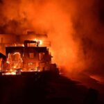 se is engulfed in flames as the Palisades Fire burns along Pacific Coast Highway in Malibu,