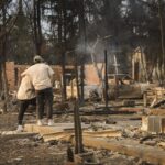 People embrace while looking over the remains of a home that was destroyed by the Eaton wildfire in the Altadena, California, USA, 09 January 2025. According to the California Governor's office, more than 7,500 firefighting and emergency personnel are involved in response efforts, as multiple wildfires are burning across thousands of acres and have forced widespread evacuations in the Los Angeles area.